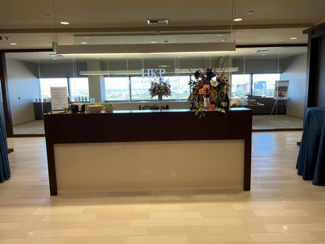 Photo of reception desk with flowers at HKP's 40th Anniversary Open House